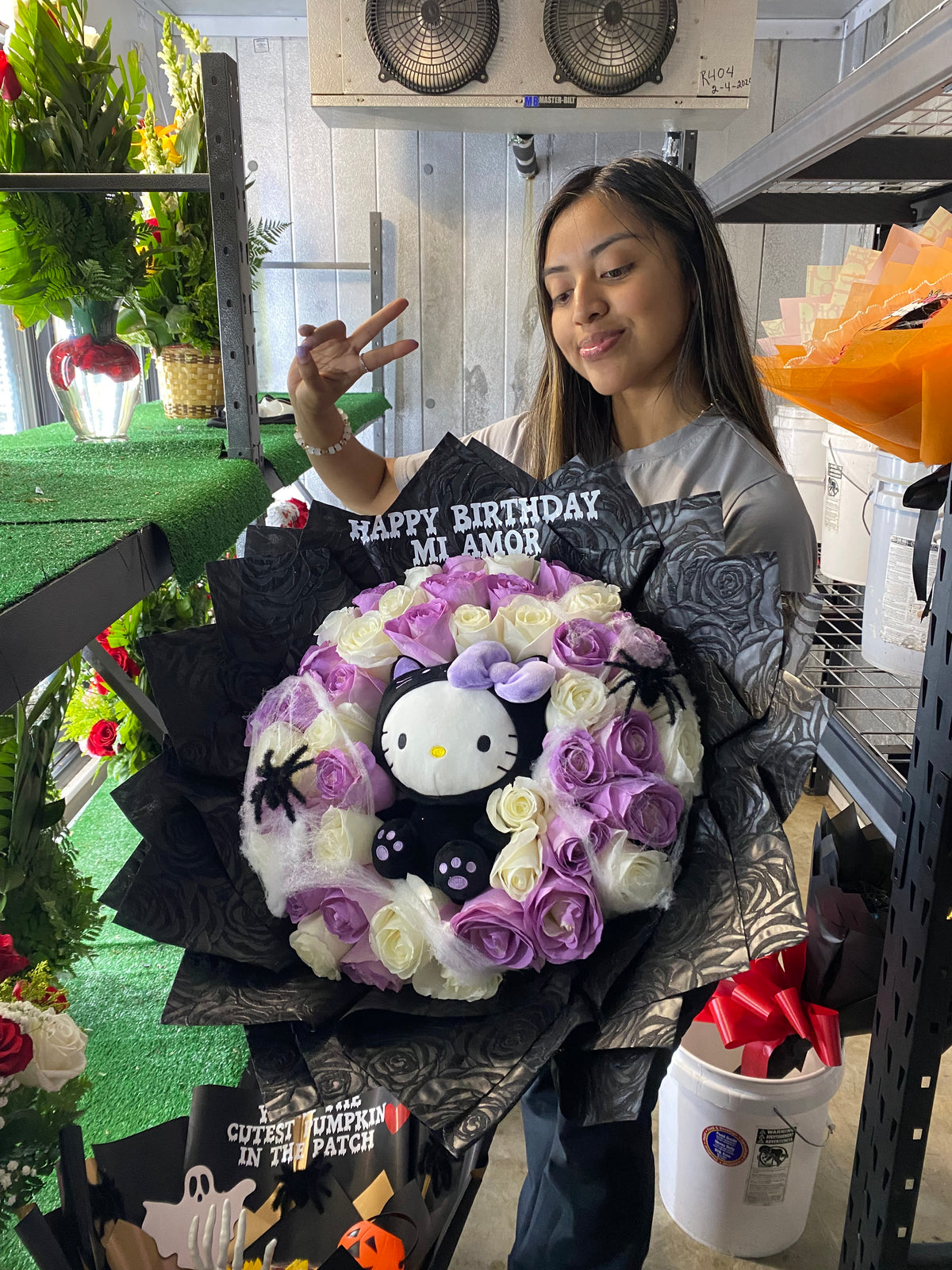Spooky hello kitty surrounded by 50 roses💜🐈⬛