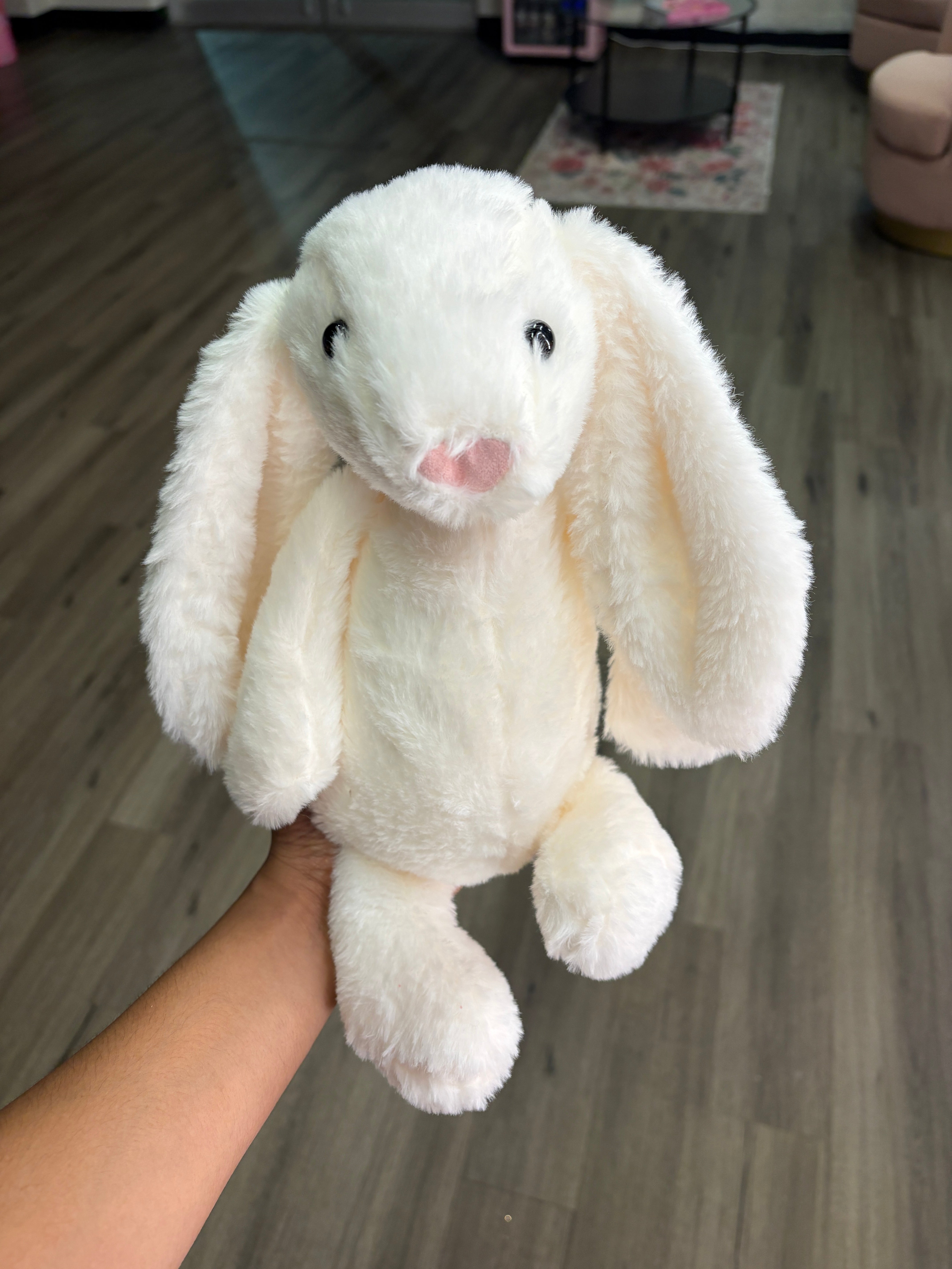 "White bunny with bows inserted in bouquet"