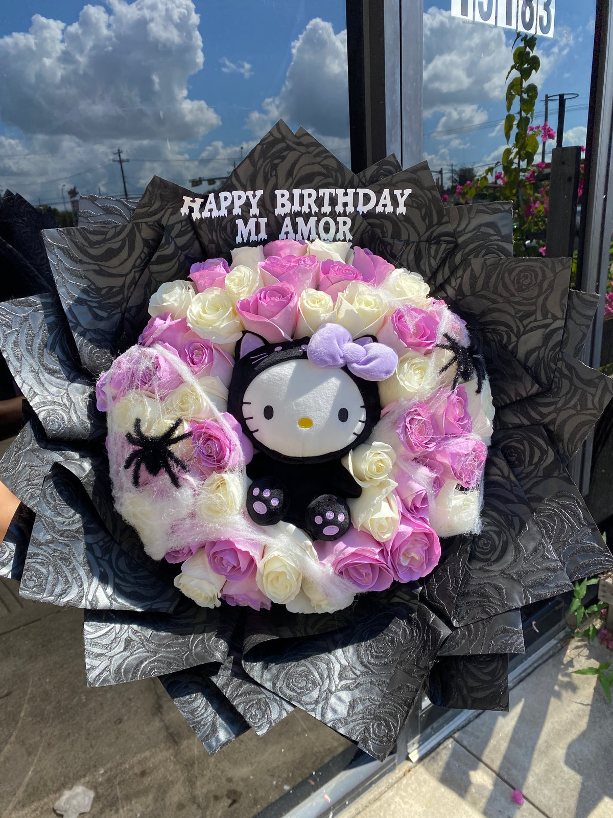 Spooky hello kitty surrounded by 50 roses💜🐈‍⬛